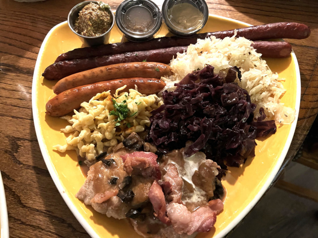 smorgasbord plate with sausages and sides.
