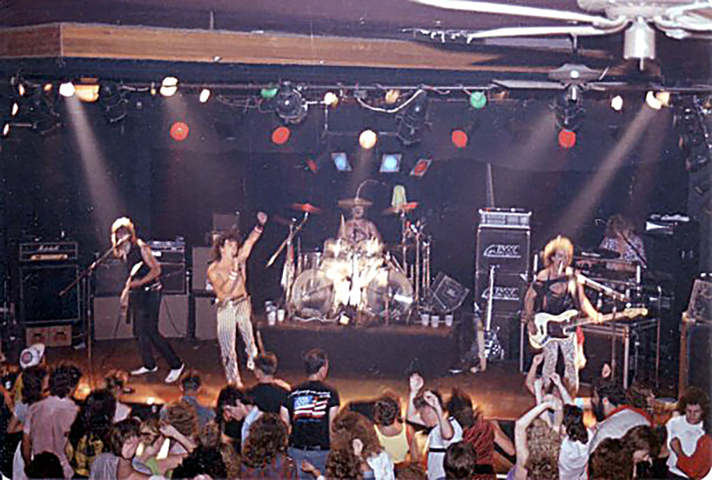 A shot of a band playing onstage in front of a packed crowd at Mabel's in Champaign, IL circa 1985.