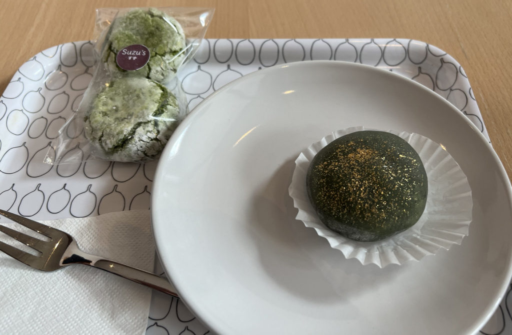 A tray with matcha chewies and a matcha mochi dusted in gold.