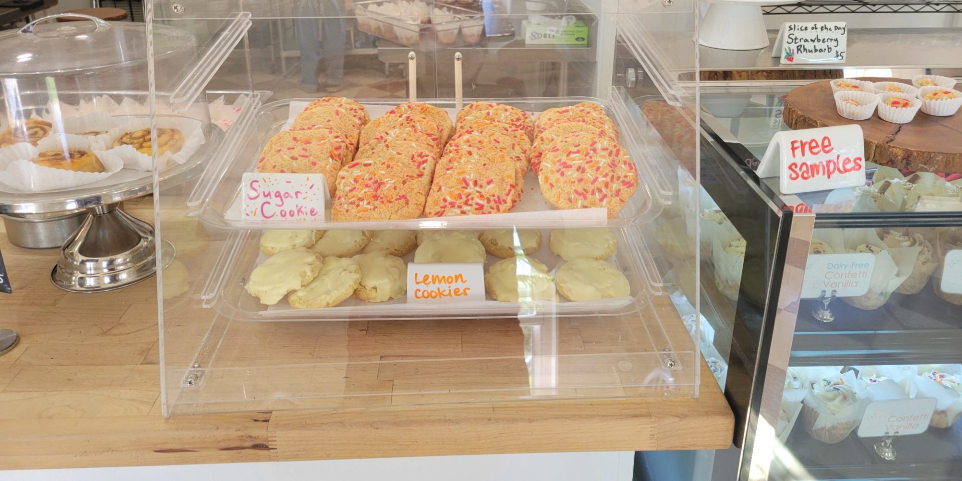 A display of dairy free and gluten free cookies with free samples nearby.
