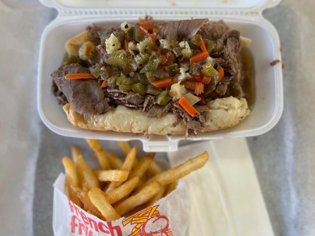 Windy City Express' Italian beef sandwich with fries on a white paper lined tray.
