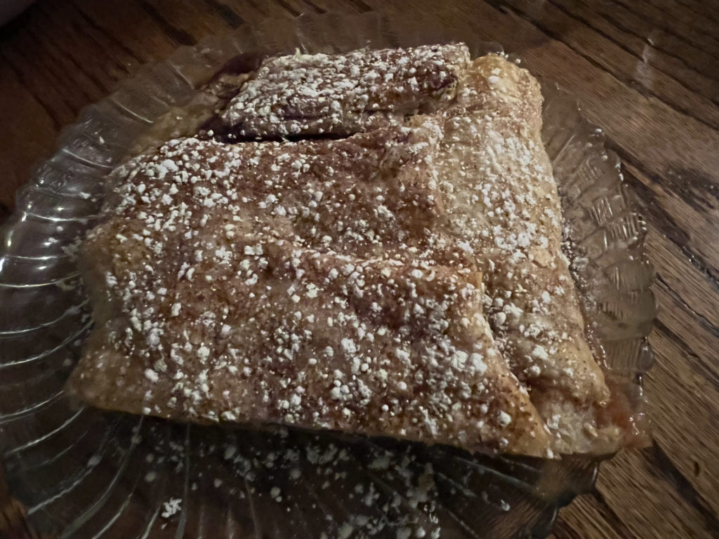 Apple strudel with powdered sugar on top.