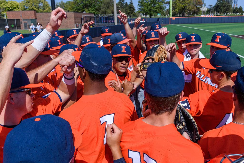 Illini baseball team huddles together wearing orange jerseys before the game between the Indiana State Sycamores and the Illinois Fighting Illini at Illinois Field in Champaign, IL.