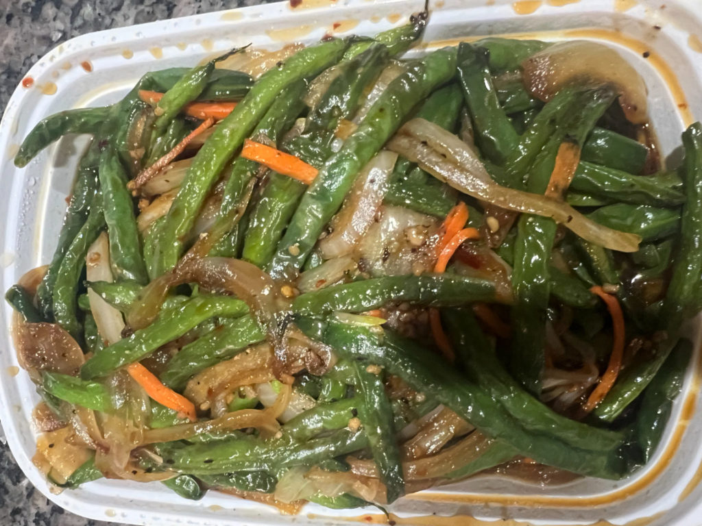 The green beans from Peking Garden in a white takeout container.
