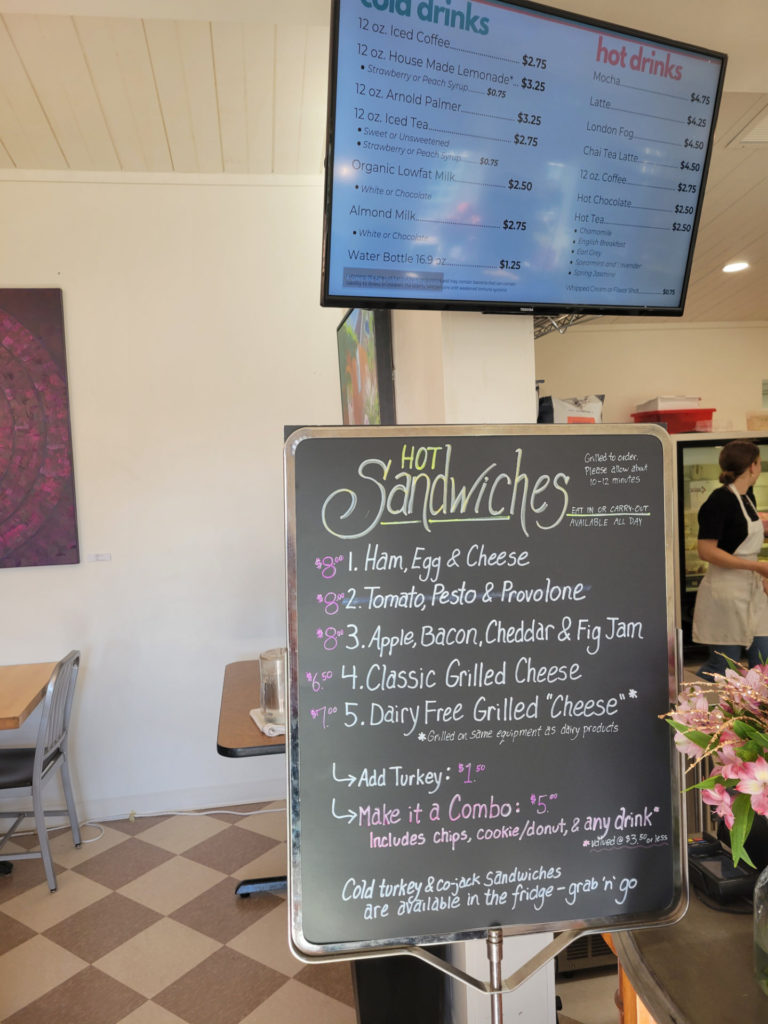 Various menus showing cold drinks, hot drinks, and hot sandwich options.