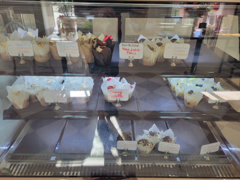 A display of many different cupcake flavors with some also dairy free.