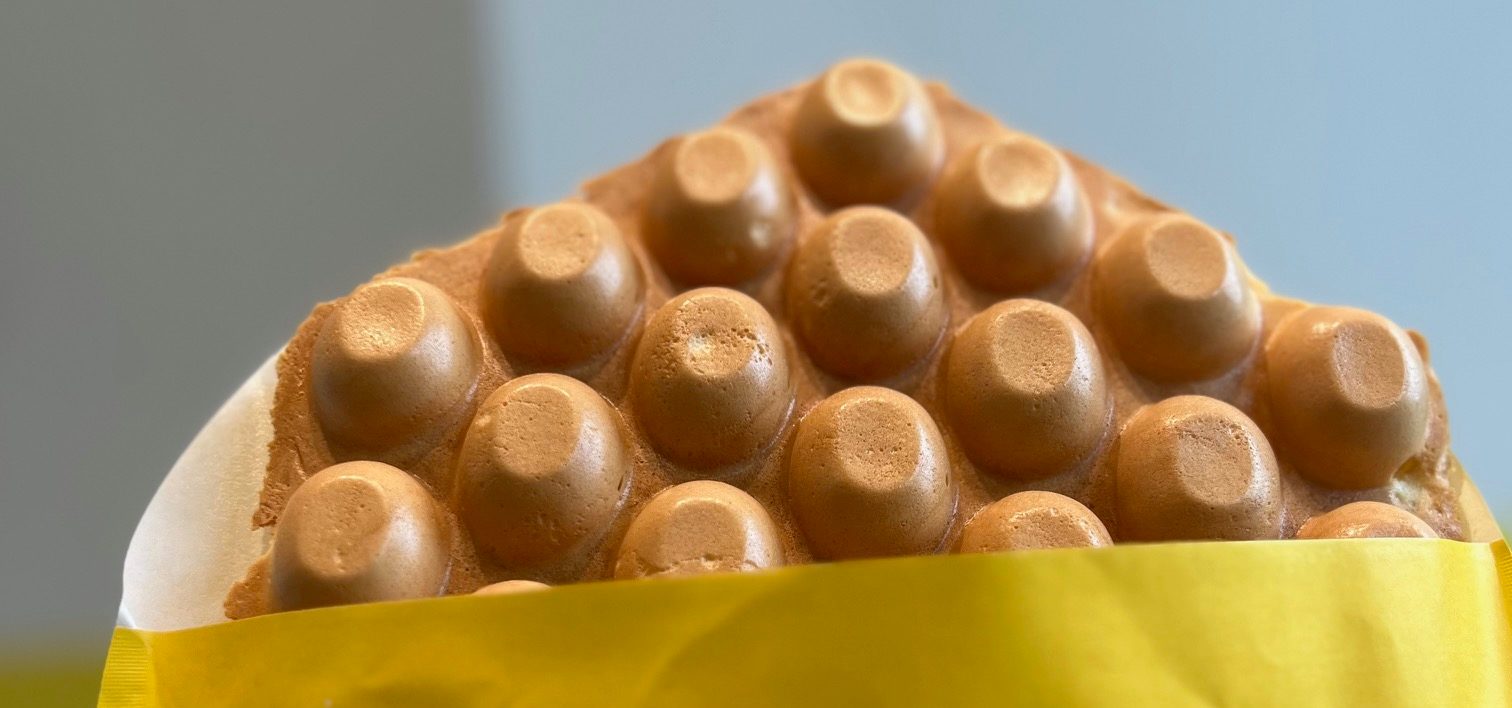 A bubble waffle in a yellow paper.