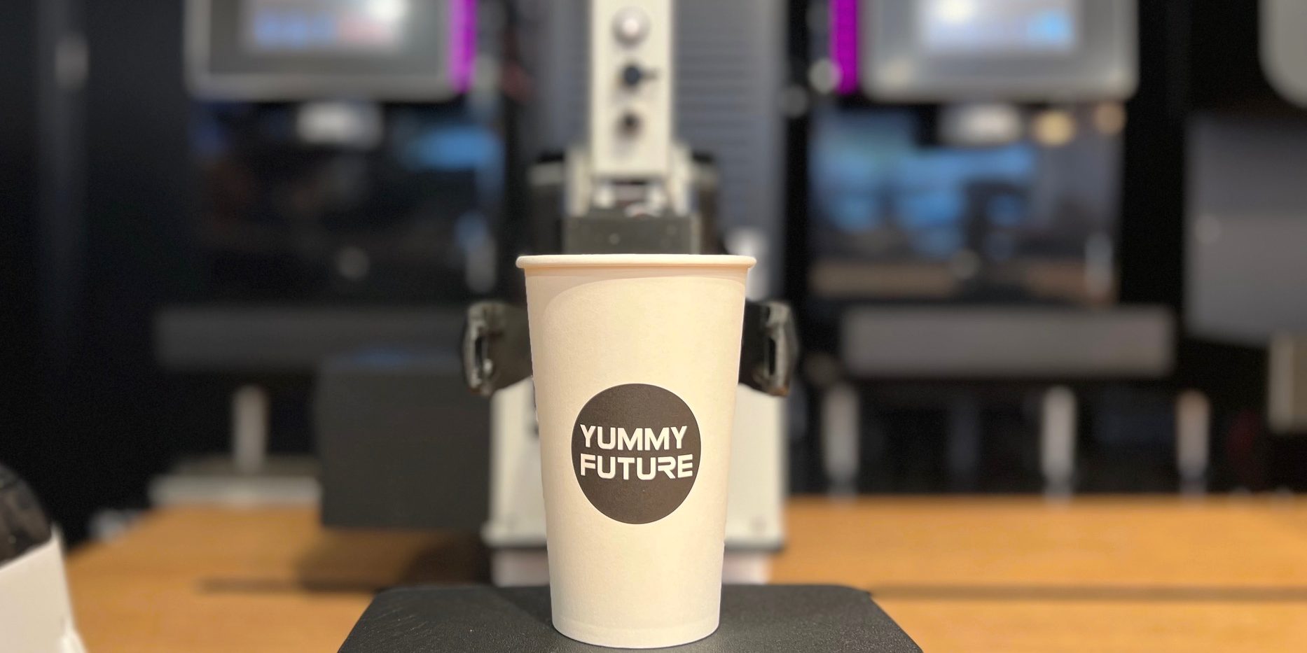 A white cup with "yummy future" on it.
